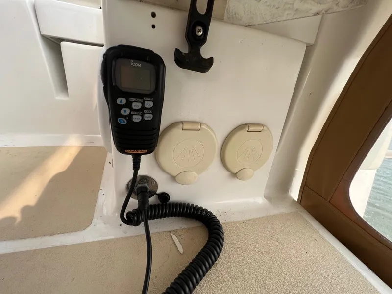 Slide: The Image of VHF radio and outlets on a 2007 Tartan 3400 boat dashboard. - 35
