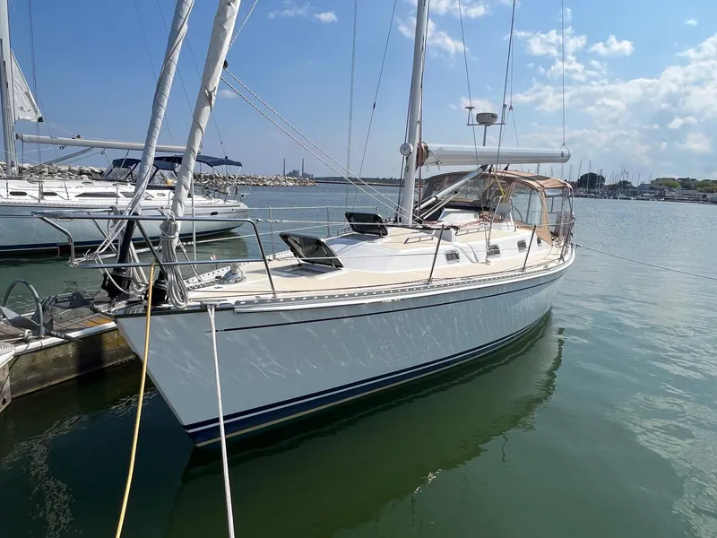 Slide: The Image of 2007 Tartan 3400 sailboat docked in a marina under a clear blue sky. - 4