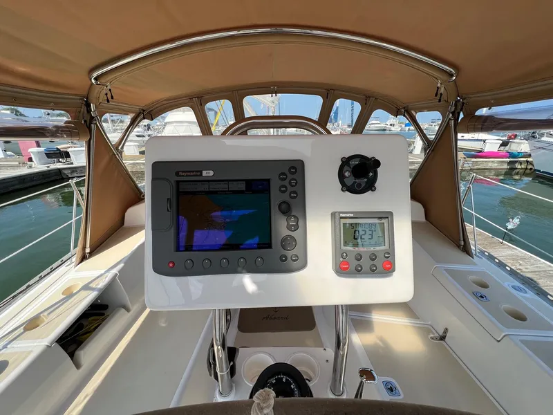 Slide: The Image of Cockpit of 2007 Tartan 3400 sailboat with navigation instruments and marina view. - 41