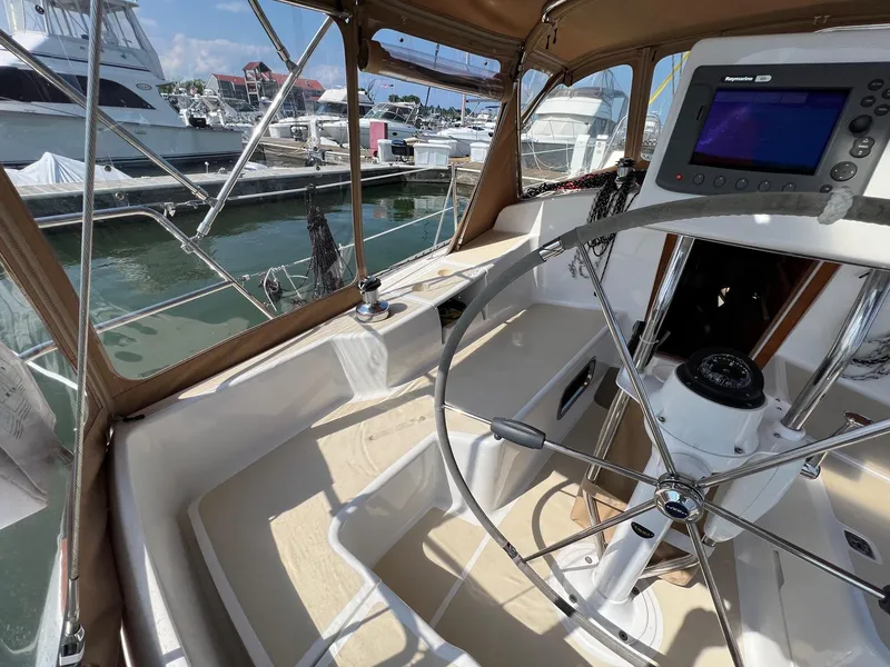 Slide: The Image of Cockpit of 2007 Tartan 3400 sailboat with steering wheel and navigation equipment at marina. - 43