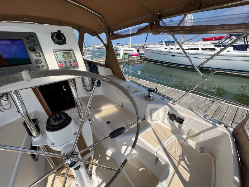 Slide: The Image of Cockpit of 2007 Tartan 3400 sailboat with steering wheel and navigation instruments. - 44