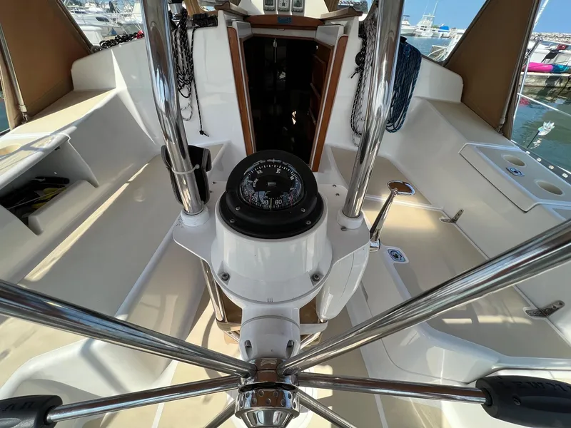 Slide: The Image of Cockpit of 2007 Tartan 3400 sailboat with steering wheel and compass, docked at marina. - 45