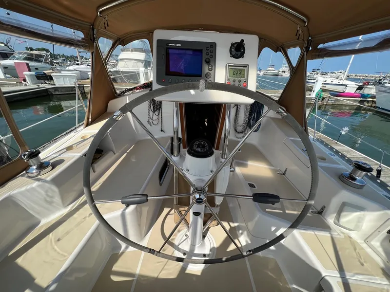 Slide: The Image of 2007 Tartan 3400 yacht cockpit with steering wheel and navigation equipment at marina. - 46