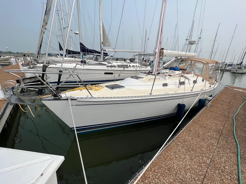 Slide: The Image of 2007 Tartan 3400 sailboat docked in a marina, surrounded by other boats. - 8