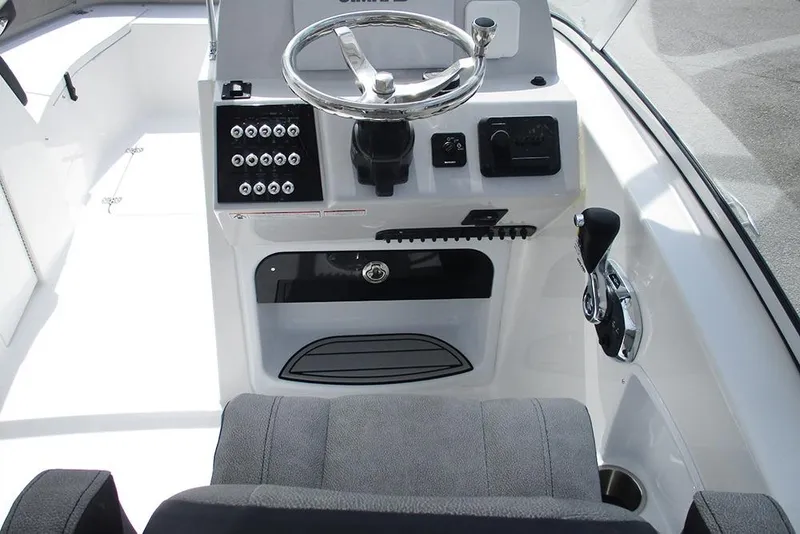 Slide: The Image of 2026 Sea Pro 240 Dual Console Deluxe boat cockpit with steering wheel and controls. - 16