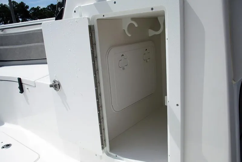 Slide: The Image of Storage compartment on 2026 Sea Pro 240 Dual Console Deluxe boat, open door view. - 23