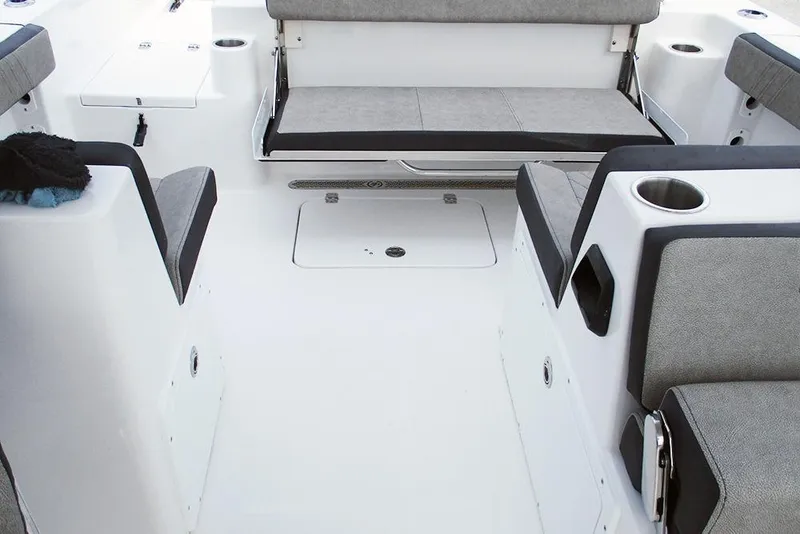 Slide: The Image of 2026 Sea Pro 240 Dual Console Deluxe interior with gray seating and cup holders. - 27