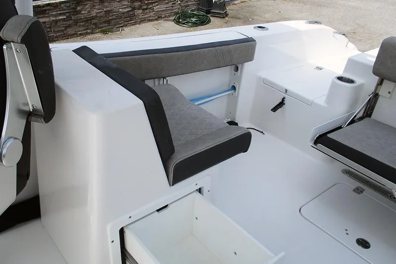 Slide: The Image of 2026 Sea Pro 240 Dual Console Deluxe boat interior with seating and storage compartments. - 30