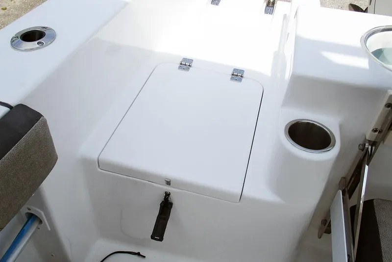 Slide: The Image of 2026 Sea Pro 240 Dual Console Deluxe boat interior with storage compartment and cup holder. - 34