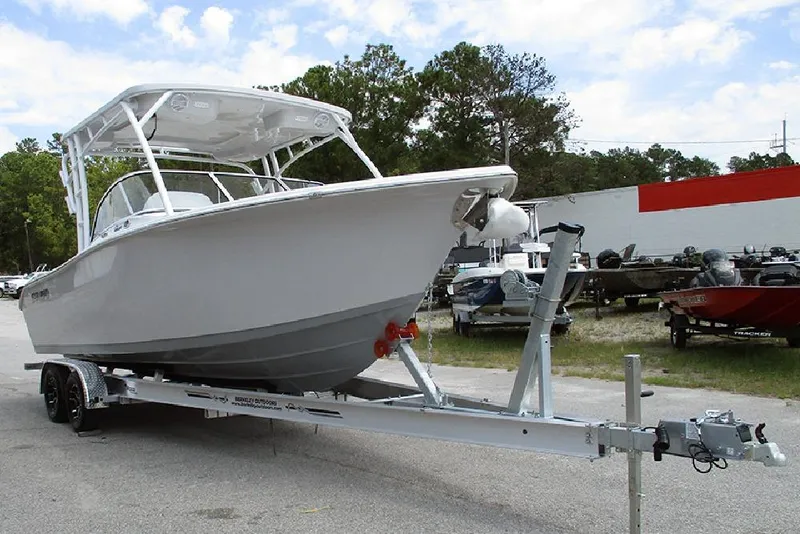 Slide: The Image of 2026 Sea Pro 240 Dual Console Deluxe boat on trailer, parked outdoors. - 5