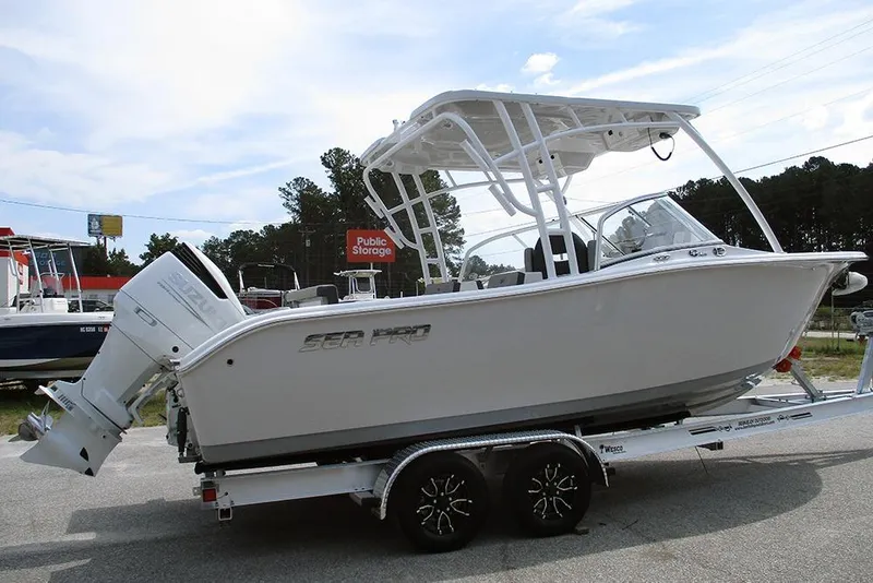 Slide: The Image of 2026 Sea Pro 240 Dual Console Deluxe boat on trailer, parked outdoors. - 6