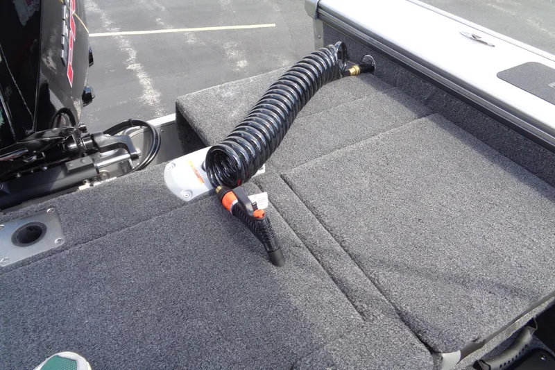 Slide: The Image of 2026 Lund 2075 Pro-V Sport boat deck with coiled hose and motor detail. - 12