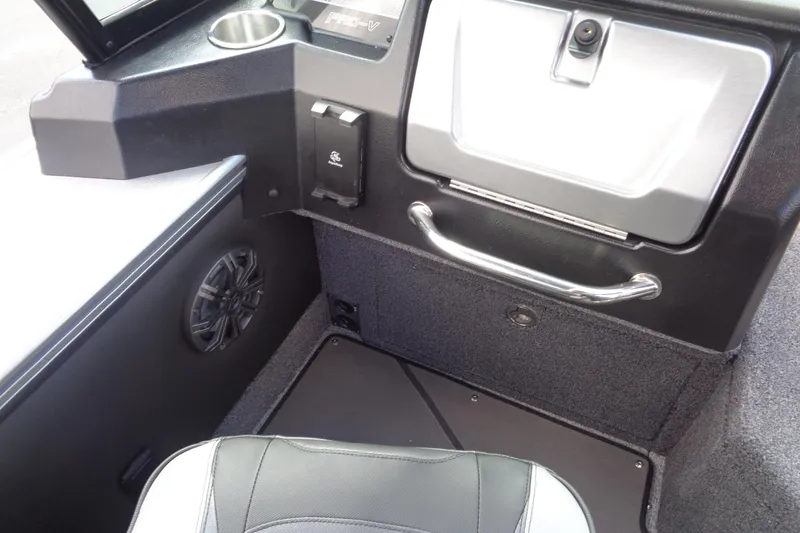 Slide: The Image of Interior of 2026 Lund 2075 Pro-V Sport boat, featuring speaker and storage compartment. - 17