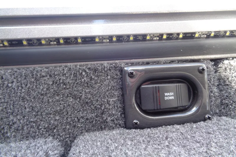 Slide: The Image of Wash down switch on 2026 Lund 2075 Pro-V Sport boat with LED strip lighting. - 22