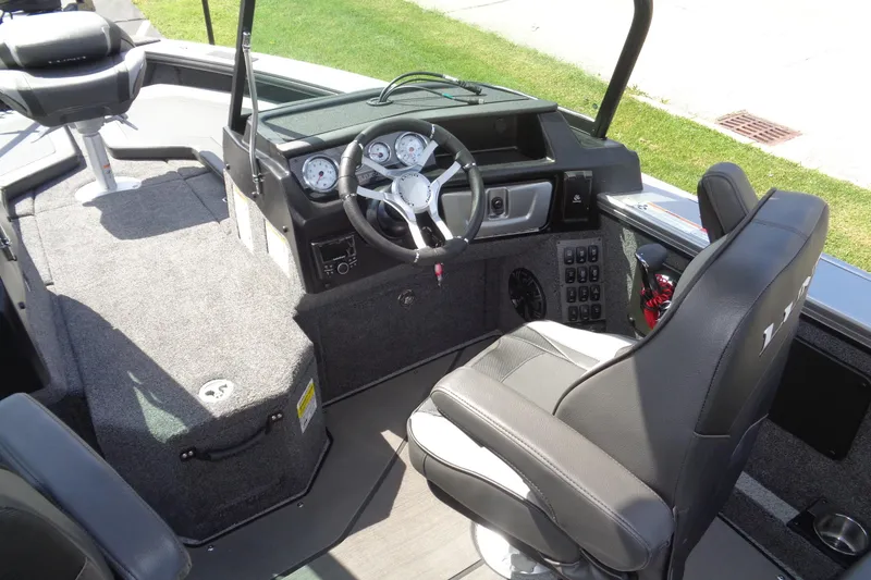 Slide: The Image of 2026 Lund 2075 Pro-V Sport boat interior with steering wheel and seating. - 24