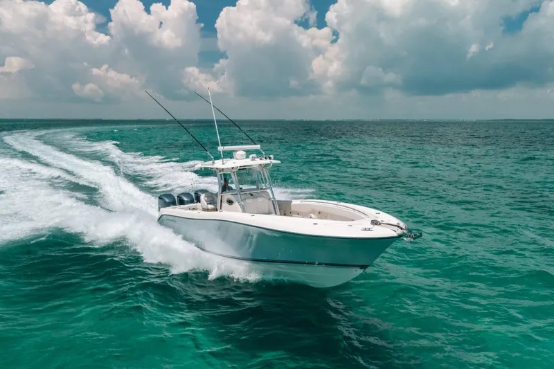 The Image of 2008 Hydra-Sports Vector 3300 CC cruising on turquoise ocean under cloudy sky. - 1