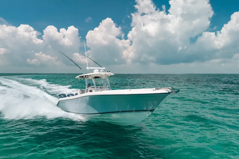 Slide: The Image of 2008 Hydra-Sports Vector 3300 CC cruising on turquoise ocean under cloudy sky. - 13