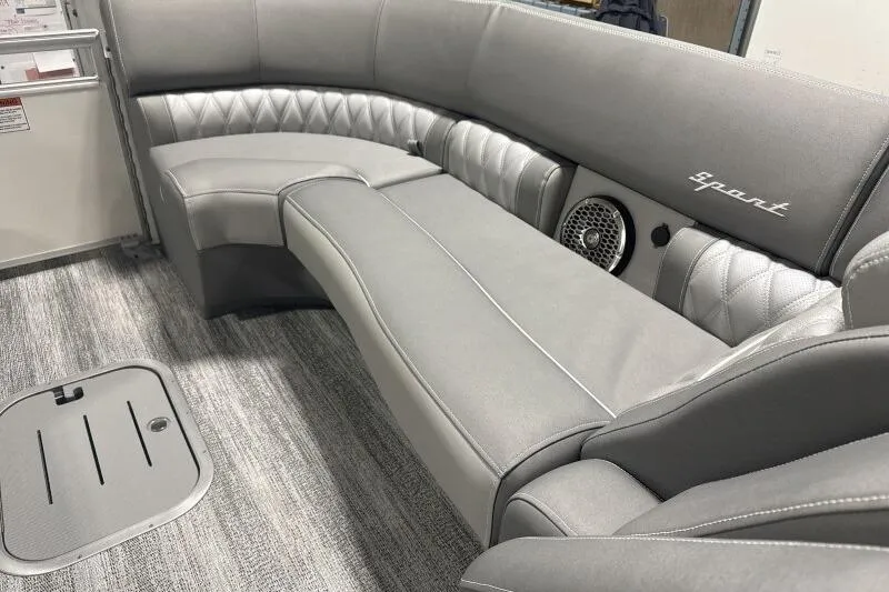 Slide: The Image of 2024 Bennington 25QFBWA boat interior with luxurious gray seating and integrated speaker system. - 4