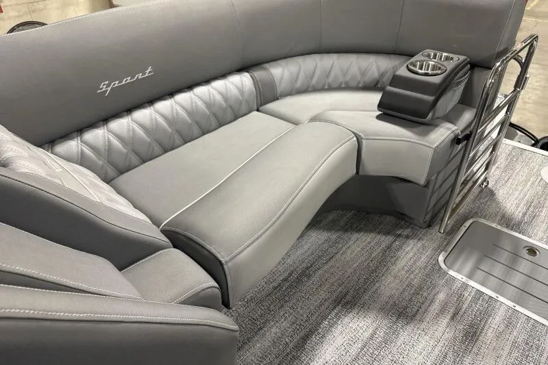 Slide: The Image of 2024 Bennington 25QFBWA boat interior with gray seating and cup holders. - 6