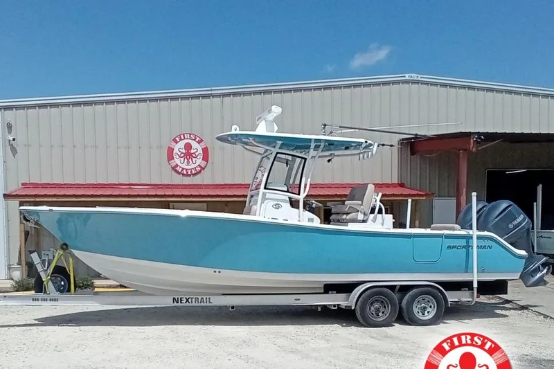 Slide: The Image of 2020 Sportsman Open 282 Center Console boat on trailer outside a warehouse. - 0