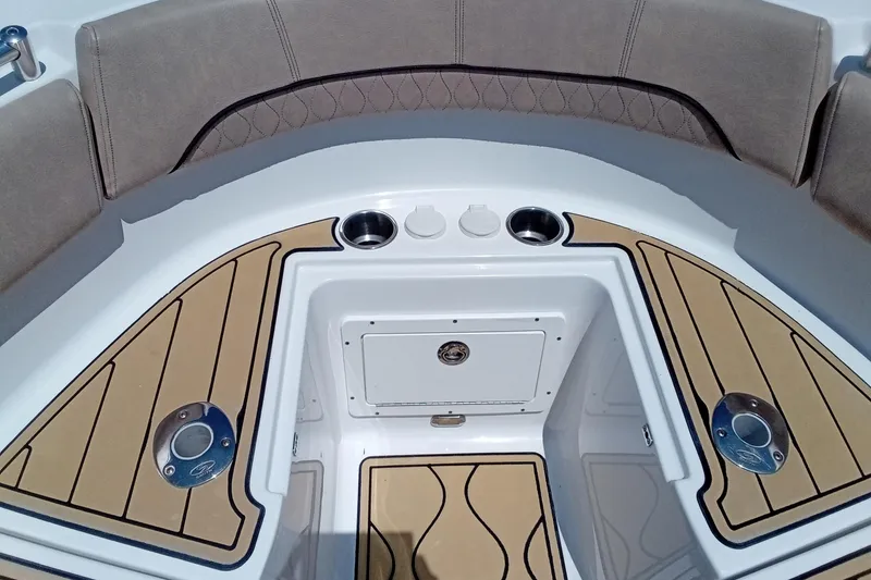 Slide: The Image of 2020 Sportsman Open 282 Center Console boat interior with cushioned seating and cup holders. - 12