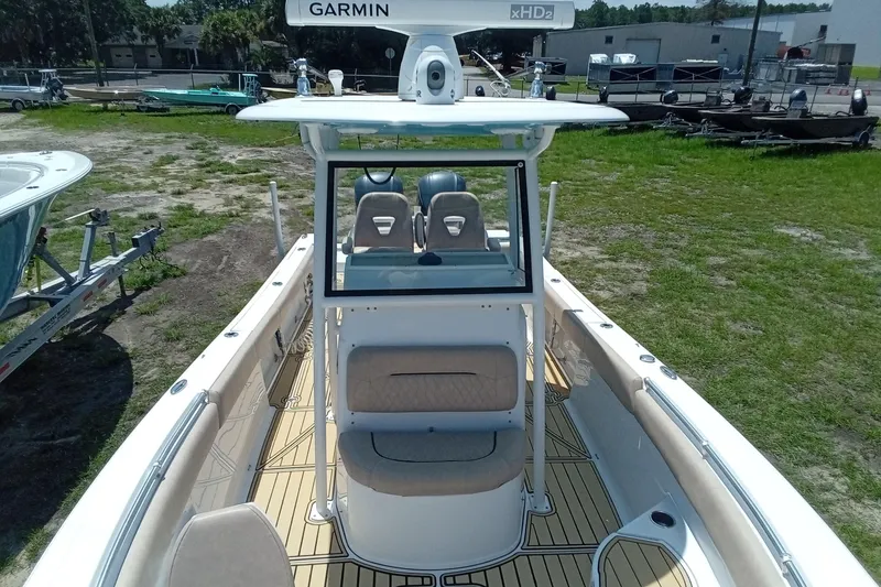 Slide: The Image of 2020 Sportsman Open 282 Center Console boat with Garmin equipment, docked outdoors. - 14