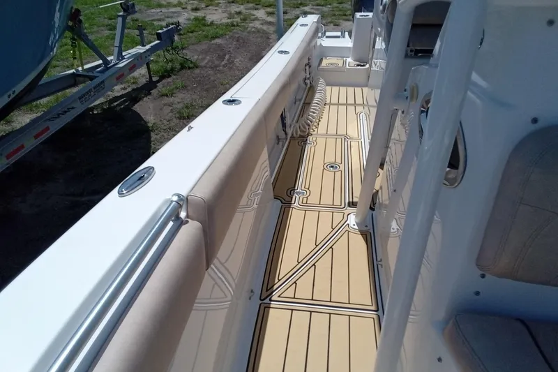 Slide: The Image of 2020 Sportsman Open 282 Center Console boat interior with teak-style flooring. - 15