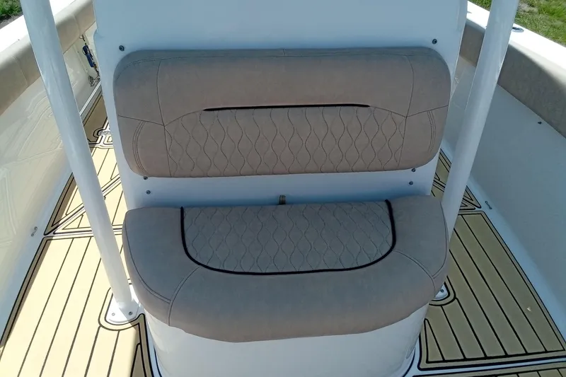 Slide: The Image of 2020 Sportsman Open 282 Center Console boat seat with beige upholstery and diamond stitching. - 16