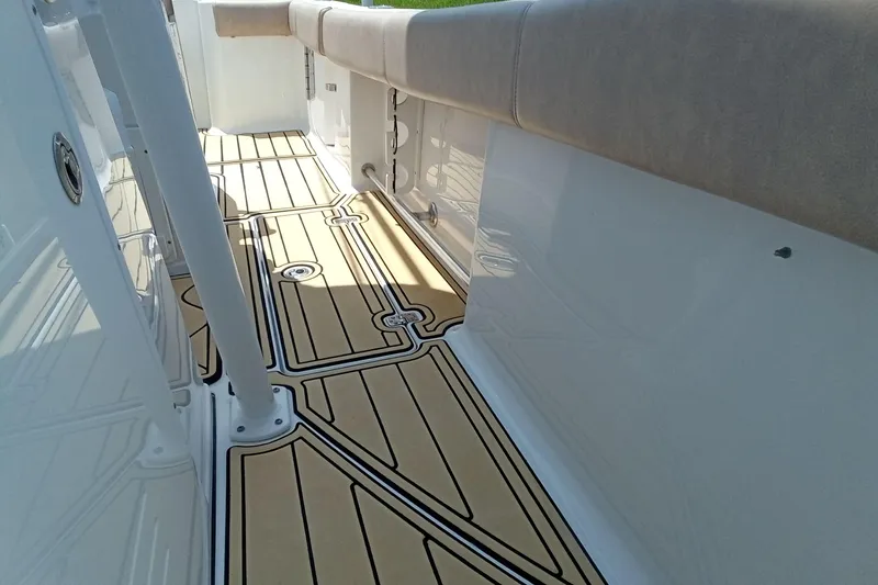 Slide: The Image of 2020 Sportsman Open 282 Center Console boat interior with cushioned seating and sleek flooring. - 17