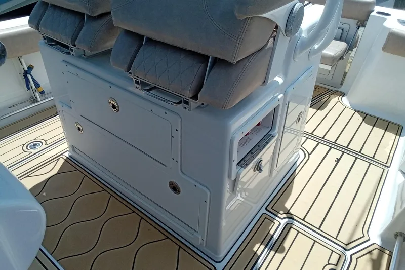Slide: The Image of 2020 Sportsman Open 282 Center Console boat interior with cushioned seating and storage compartments. - 18