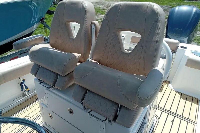 Slide: The Image of 2020 Sportsman Open 282 Center Console boat seats with armrests and diamond stitching. - 19