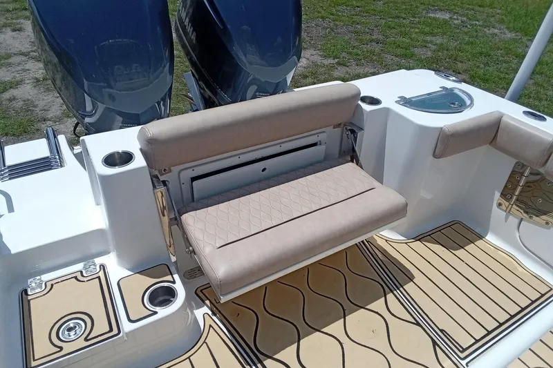 Slide: The Image of 2020 Sportsman Open 282 Center Console boat with beige seating and dual Yamaha engines. - 21