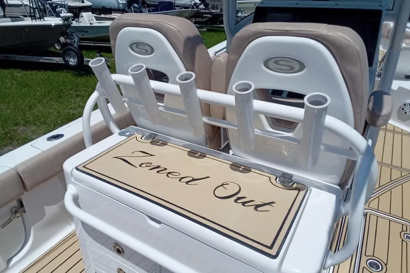 Slide: The Image of 2020 Sportsman Open 282 Center Console boat interior with rod holders and "Zoned Out" text. - 22