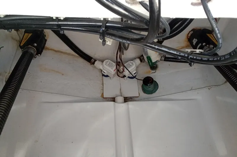 Slide: The Image of 2020 Sportsman Open 282 Center Console bilge area with wiring and hoses. - 24