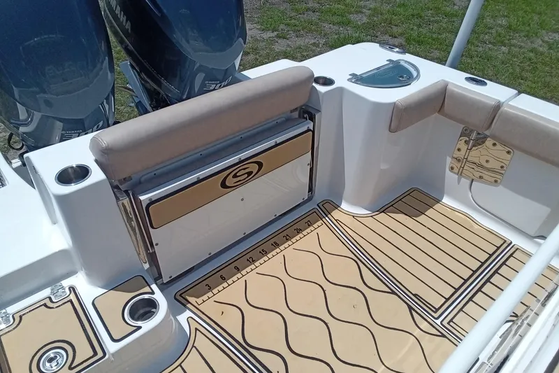 Slide: The Image of 2020 Sportsman Open 282 Center Console boat interior with Yamaha engines and cushioned seating. - 25