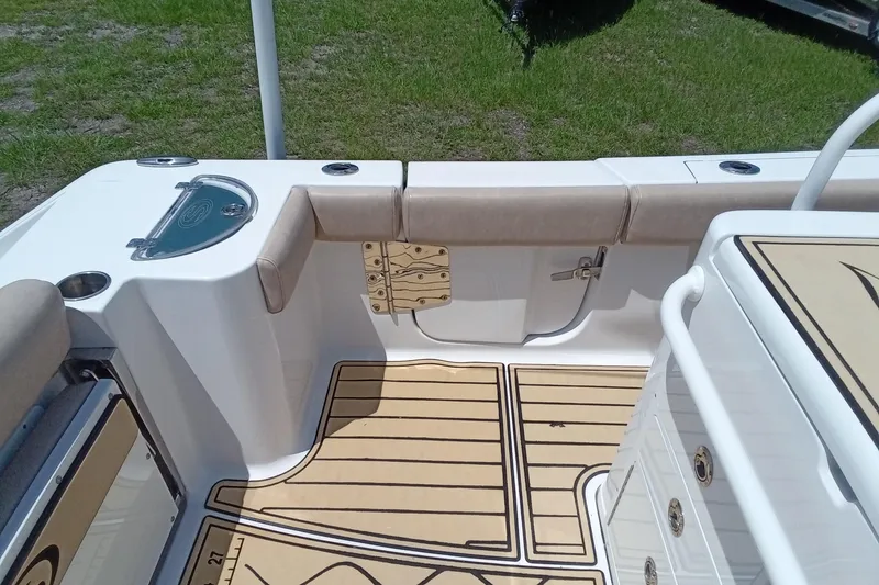 Slide: The Image of 2020 Sportsman Open 282 Center Console boat interior with cushioned seating and teak-style flooring. - 26