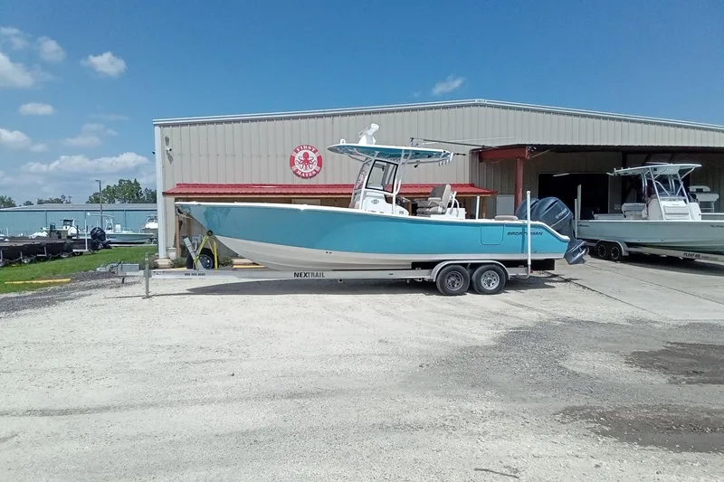Slide: The Image of 2020 Sportsman Open 282 Center Console boat on trailer outside a warehouse. - 28