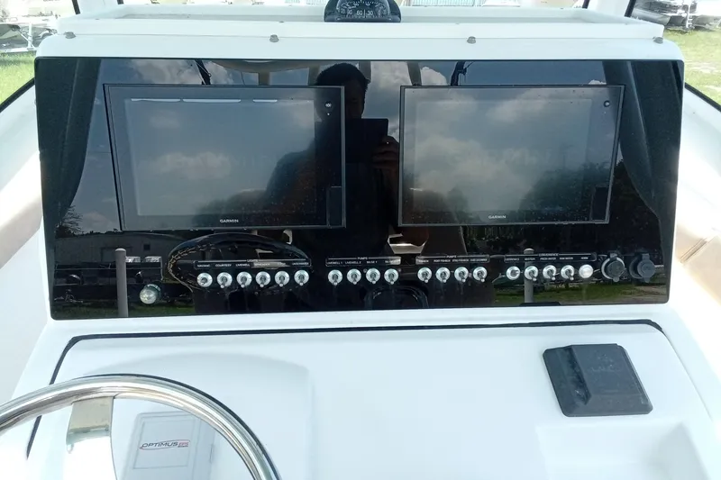 Slide: The Image of 2020 Sportsman Open 282 Center Console dashboard with dual Garmin displays and control switches. - 3