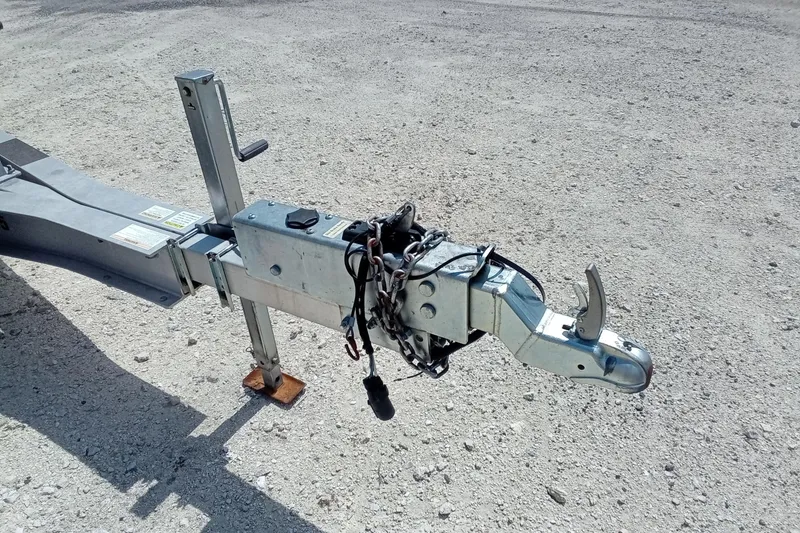 Slide: The Image of Trailer hitch of a 2020 Sportsman Open 282 Center Console on gravel surface. - 30