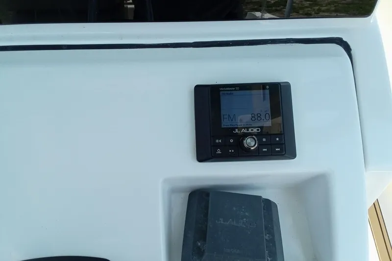 Slide: The Image of JL Audio system on 2020 Sportsman Open 282 Center Console boat dashboard. - 4