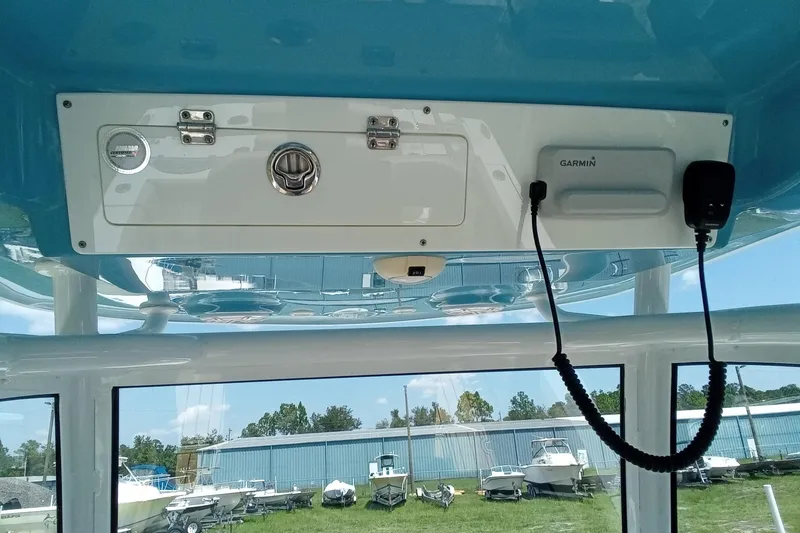 Slide: The Image of 2020 Sportsman Open 282 Center Console boat interior with Garmin equipment and storage compartment. - 7