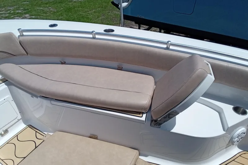 Slide: The Image of 2020 Sportsman Open 282 Center Console boat with beige seating and stainless steel railings. - 9
