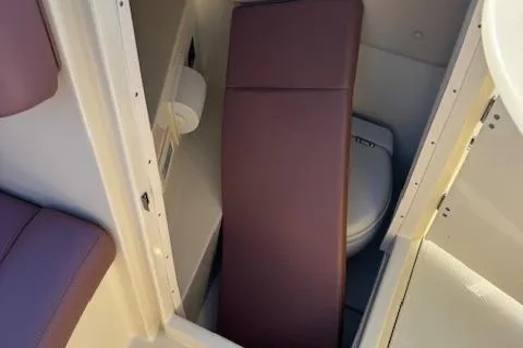 Slide: The Image of 2019 Chris-Craft Launch 30 boat interior with compact toilet and seating. - 13