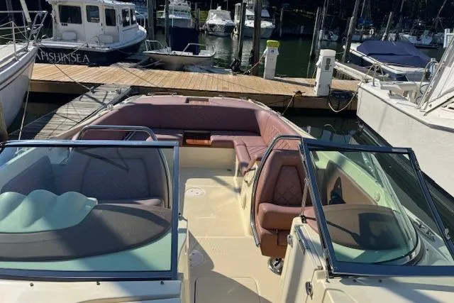 Slide: The Image of 2019 Chris-Craft Launch 30 boat docked at a marina, featuring spacious seating and elegant design. - 15
