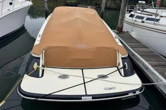 Slide: The Image of 2019 Chris-Craft Launch 30 boat with tan cover docked at marina. - 4