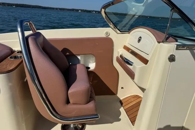Slide: The Image of 2019 Chris-Craft Launch 30 interior with leather seating and wooden accents on a sunny day. - 18
