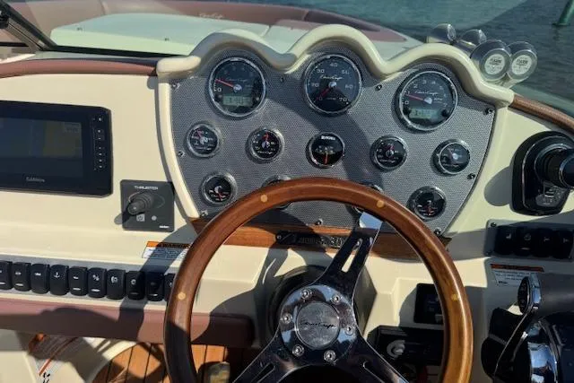 Slide: The Image of Dashboard of a 2019 Chris-Craft Launch 30 boat with gauges and wooden steering wheel. - 17