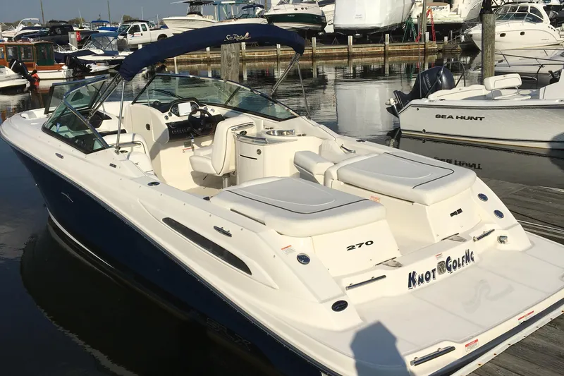 The Image of 2008 Sea Ray 270 SLX boat docked at marina, featuring spacious seating and sleek design. - 0