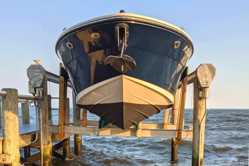 Slide: The Image of 2008 Sea Ray 270 SLX boat on lift by the water. - 1