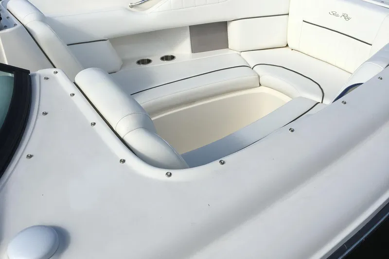 Slide: The Image of 2008 Sea Ray 270 SLX boat interior with white cushioned seating. - 10